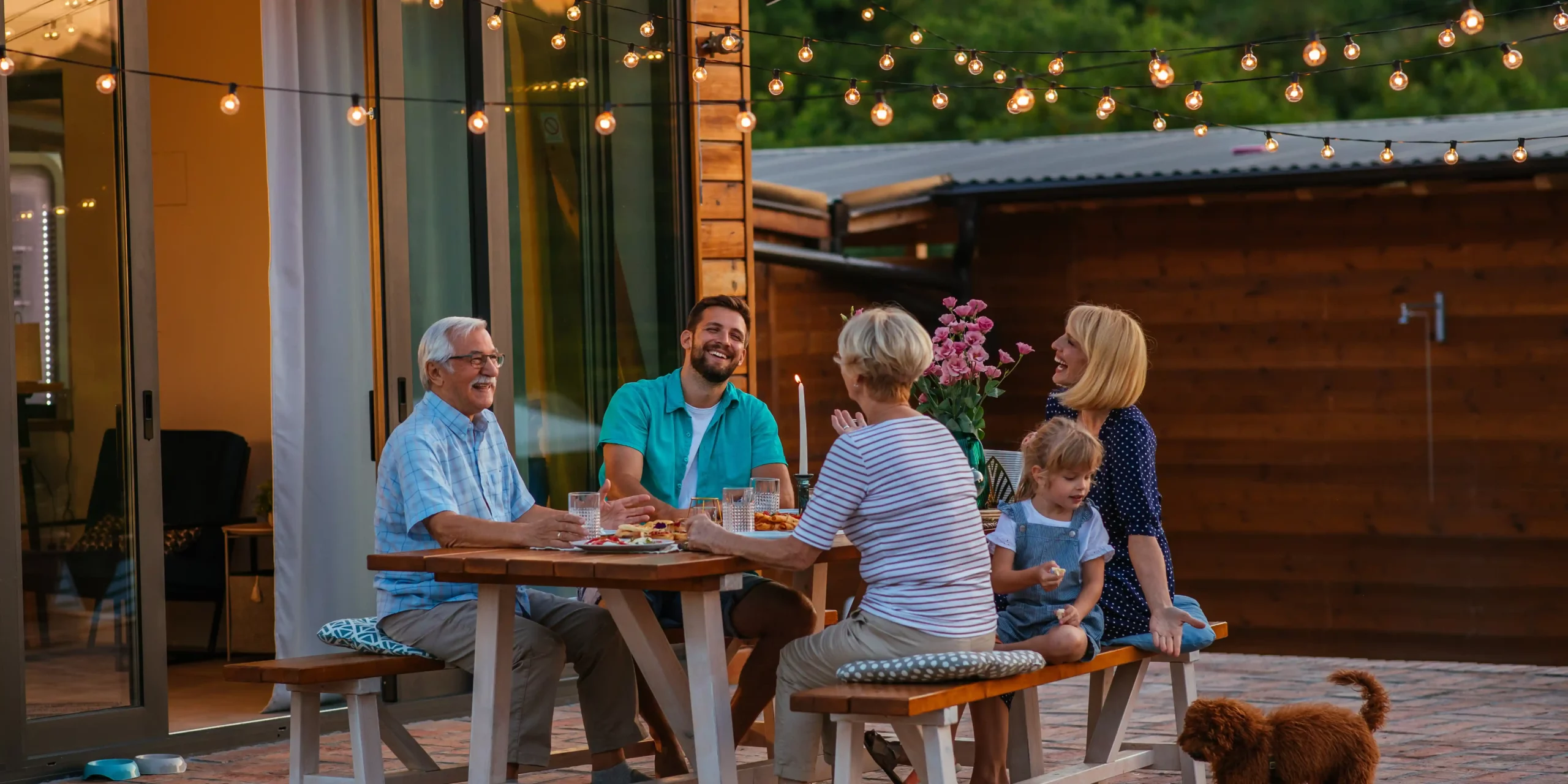 A group of people enjoying time together on a patio.